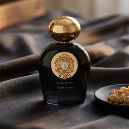Tiziana Terenzi Hale Bopp Ext on charcoal raw silk with amber resin pieces near the bottle base
