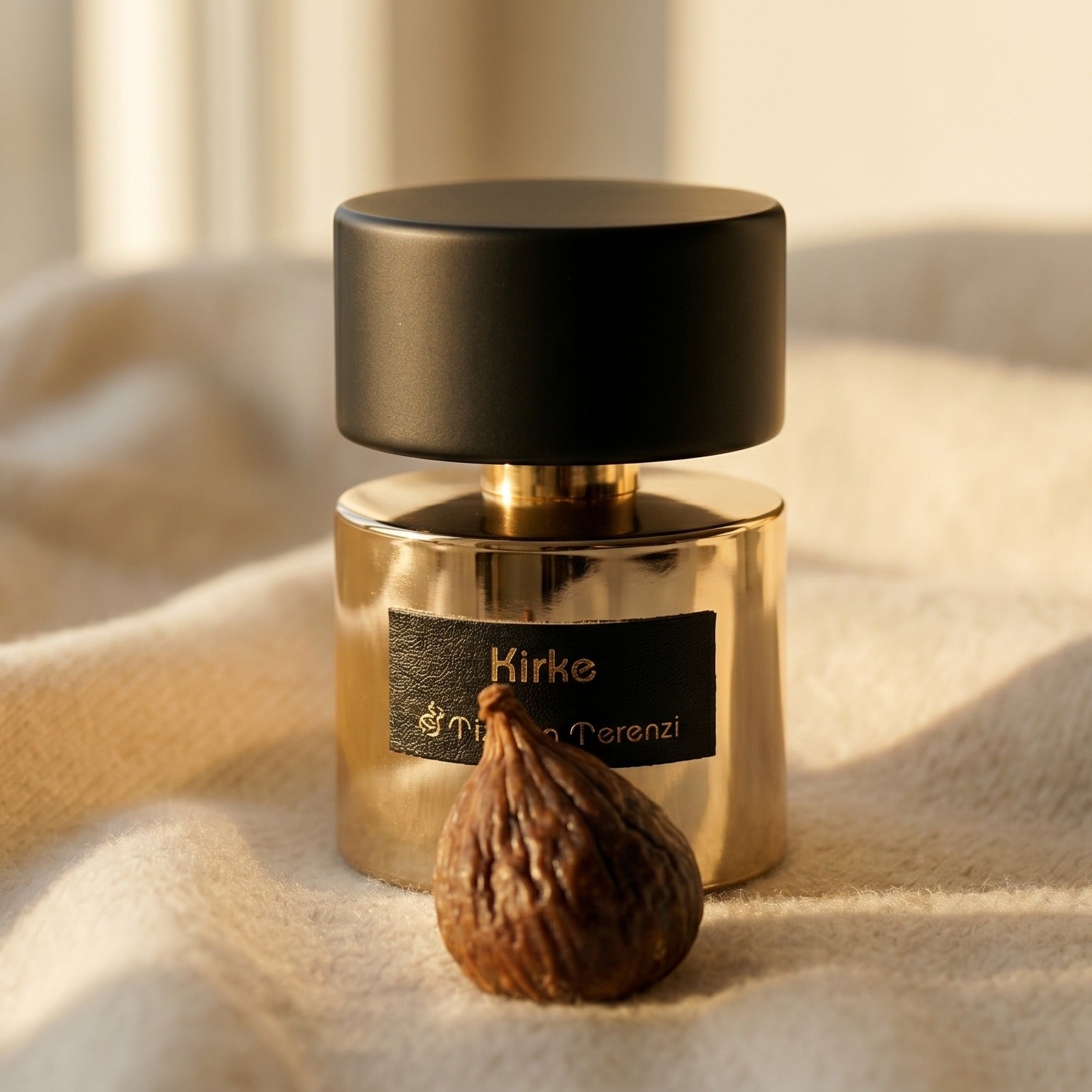 Tiziana Terenzi Kirke EDP on ivory cashmere with a small cluster of spiced walnuts