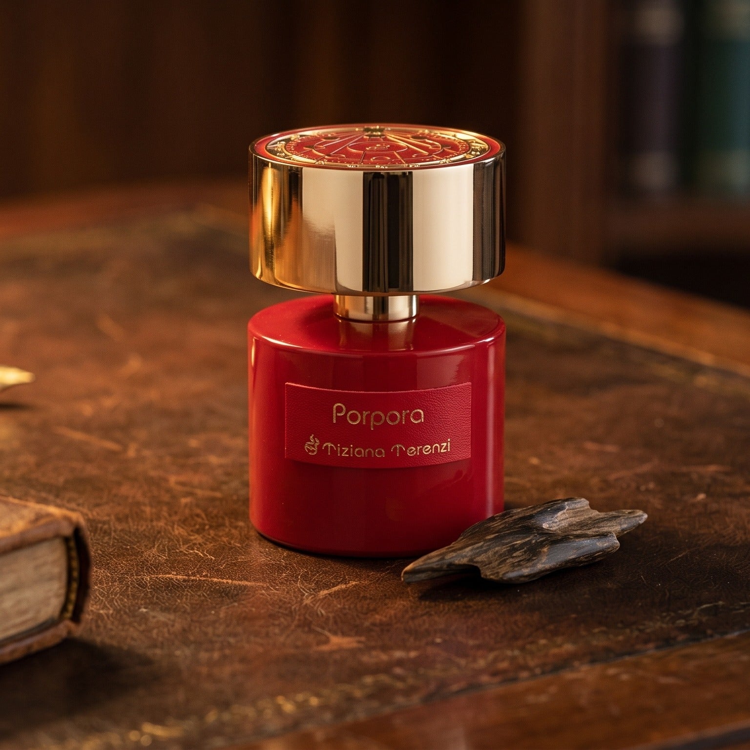 Tiziana Terenzi Porpora EDP on worn saddle-leather surface with oud resin chunks in a small dish