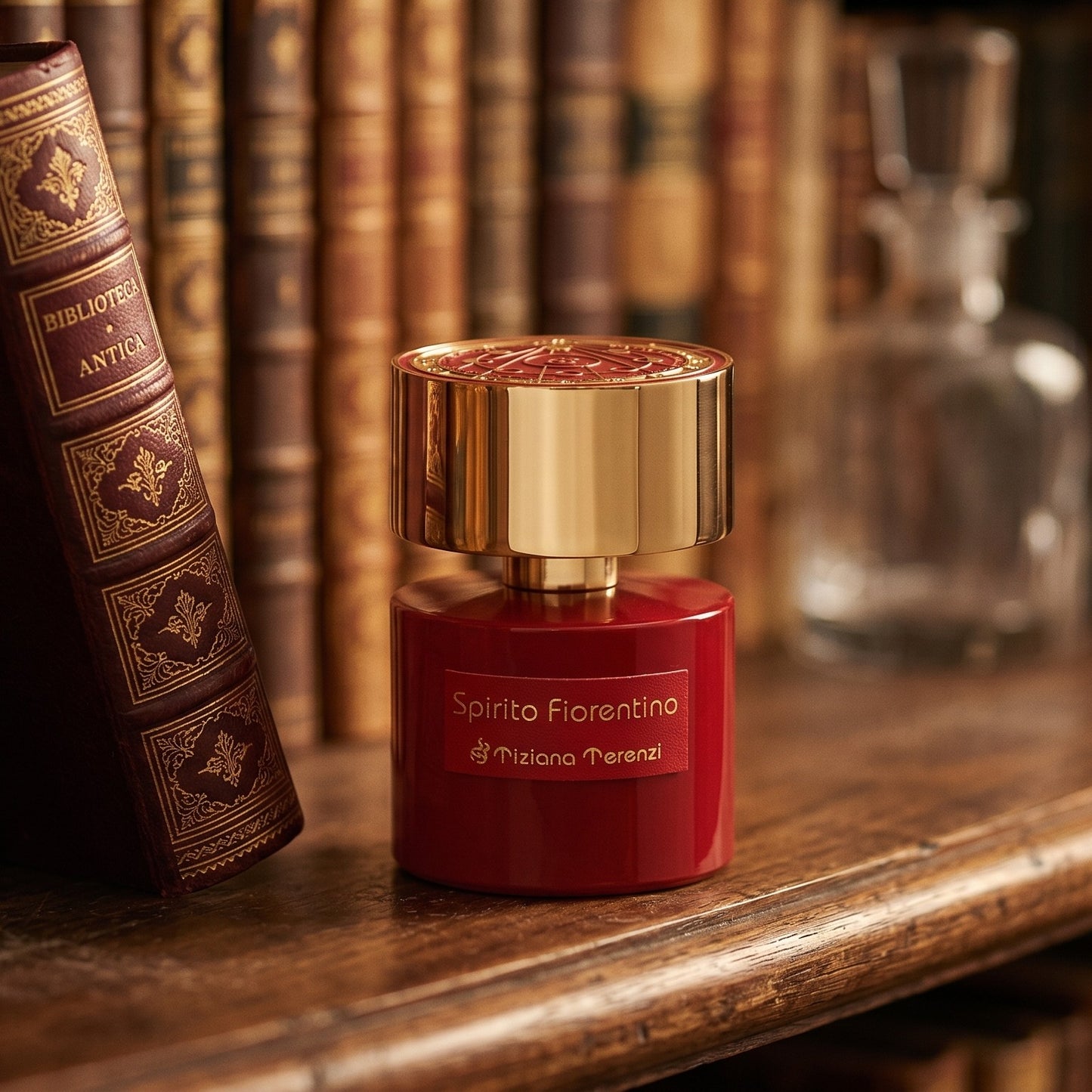 Tiziana Terenzi Spirito Fiorentino EDP on deep burgundy leather journal spread beside a crystal inkwell