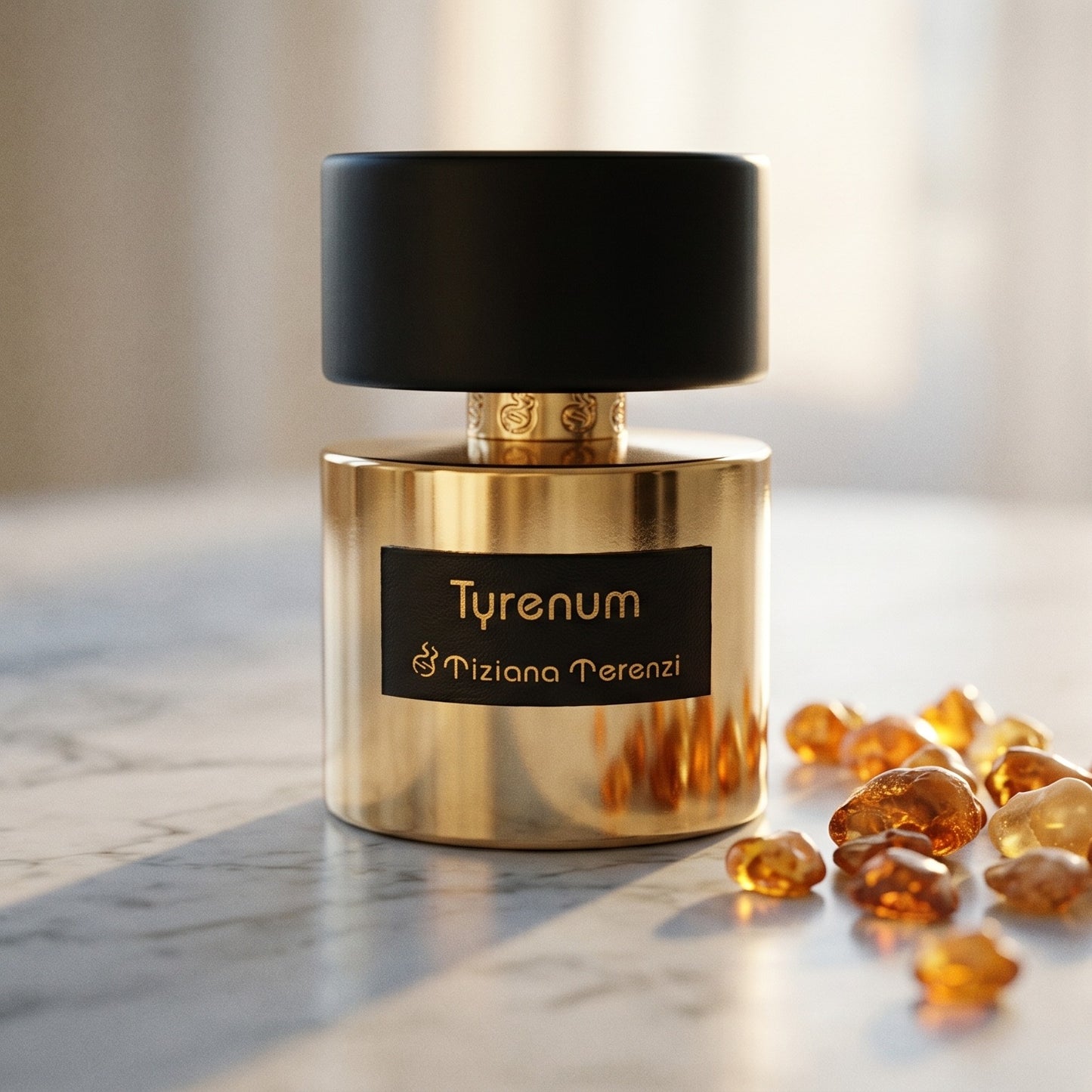 Tiziana Terenzi Tyrenum EDP on pale grey marble with amber resin beads scattered to one side