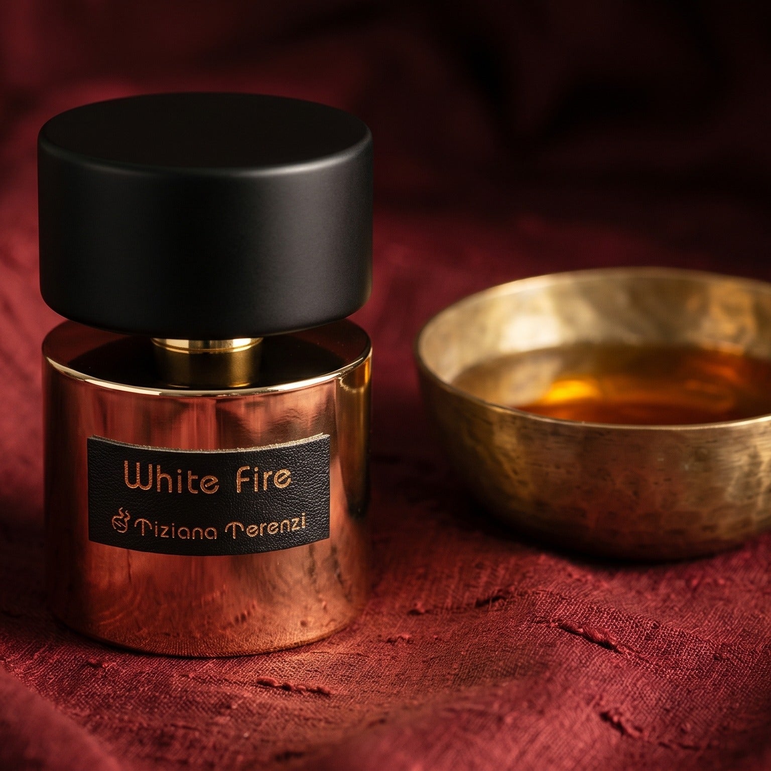 Tiziana Terenzi White Fire on cinnamon-tone silk with a shallow saucer of warm benzoin resin