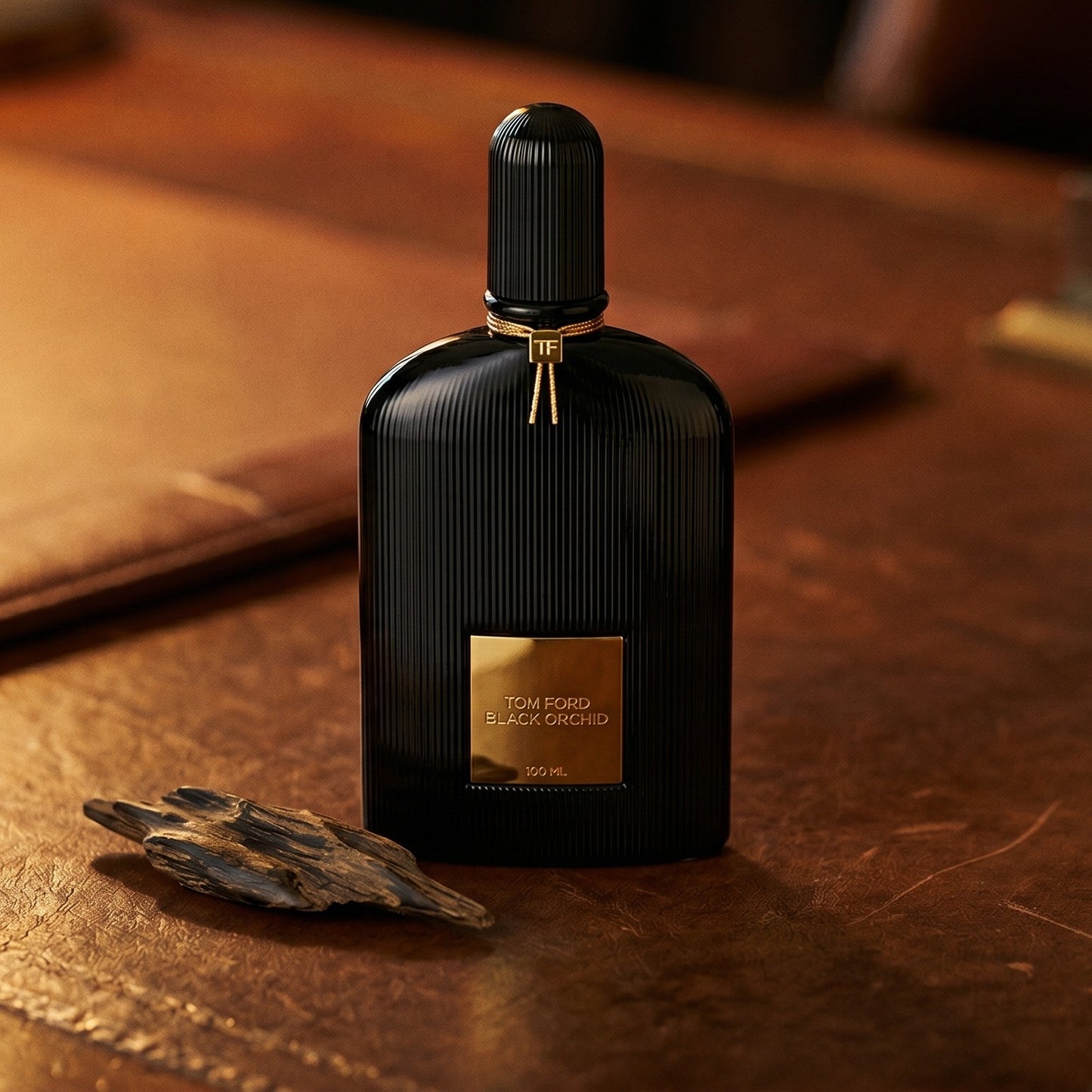 Tom Ford Black Orchid on patinated leather tray with a pinch of frankincense beside the bottle
