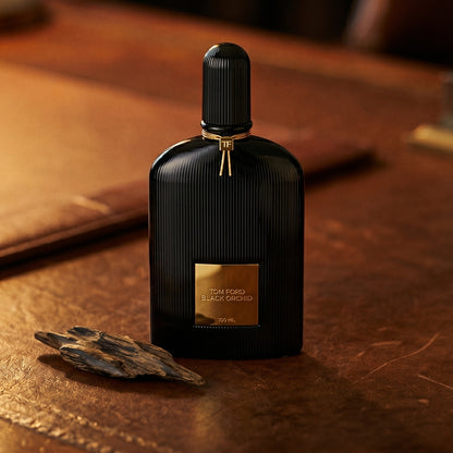 Tom Ford Black Orchid on patinated leather tray with a pinch of frankincense beside the bottle