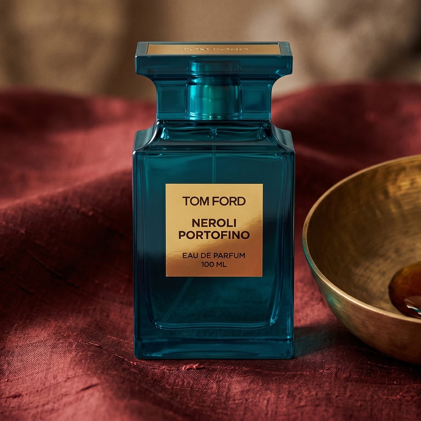 Tom Ford Neroli Portofino on burnt-orange raw silk with a brass vial of frankincense oil