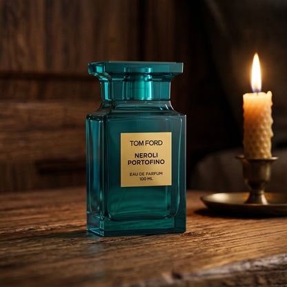 Tom Ford Neroli Portofino on aged teak with a candle burning gently to frame-right