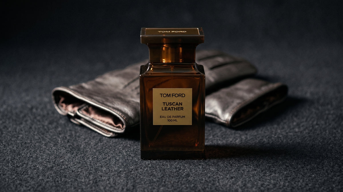 Tom Ford Tuscan Leather on charcoal felt with a silk-lined glove just behind the bottle