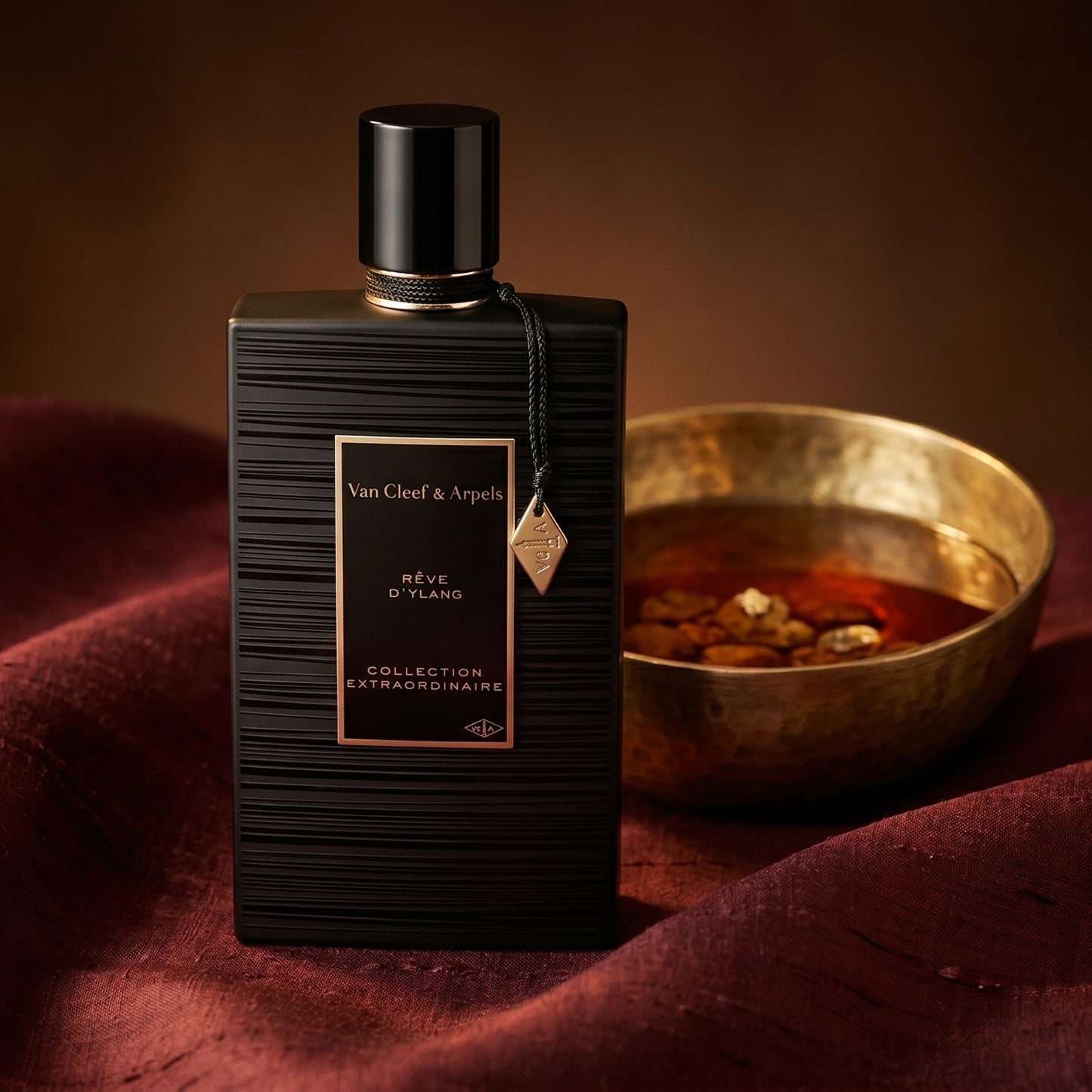 Van Cleef Reve de Ylang on deep caramel velvet with a small copper jar of resin balm