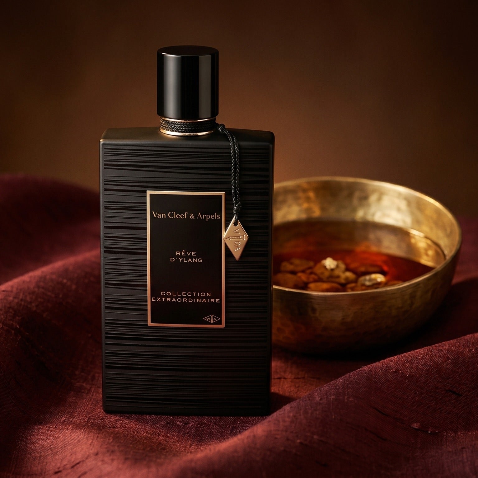 Van Cleef Reve de Ylang on deep caramel velvet with a small copper jar of resin balm