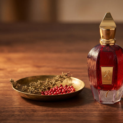Xerjoff 1 One Red Parfum - UAE Exclusive Dubai Boutique Edition on dark walnut with pink peppercorns and dried thyme in a small brass dish