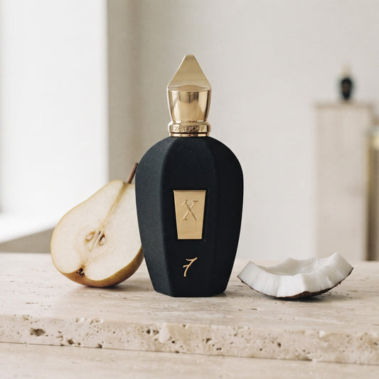 Xerjoff 7 Seven Black Flacon Parfum - UAE Exclusive Dubai Boutique Edition on pale travertine with a halved pear and a shard of fresh coconut