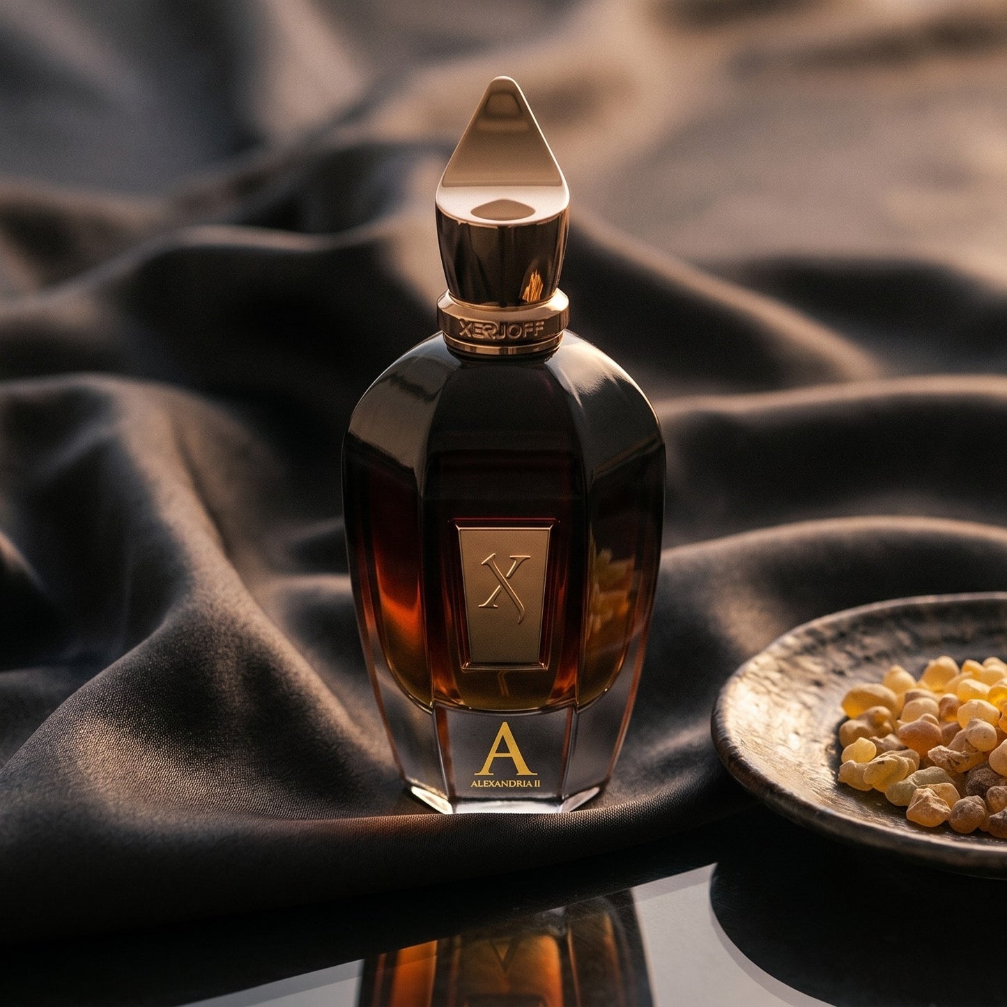 Xerjoff Alexander II on burnt-orange silk with smoldering agarwood on a stone dish