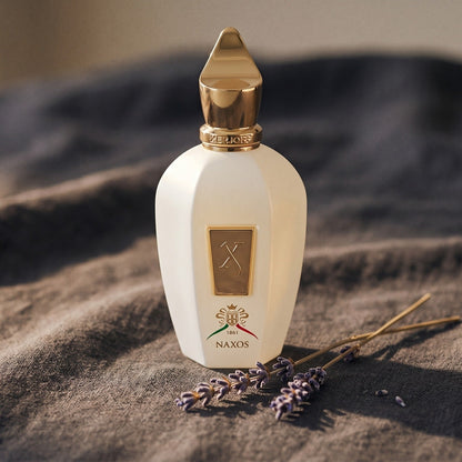 Xerjoff Naxos EDP on charcoal linen with a sprig of dried lavender