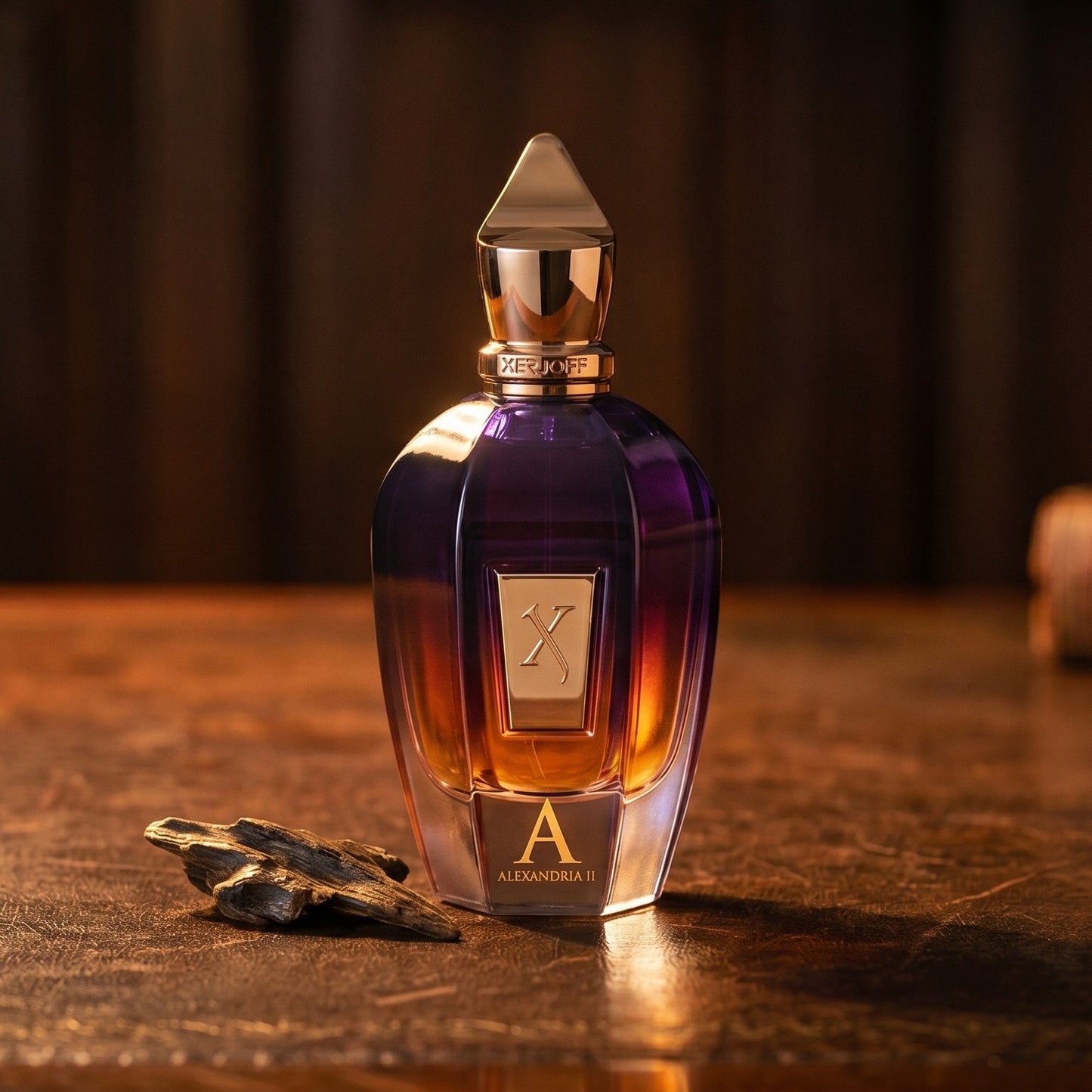Xerjoff Oud Stars Alexandria II EDP on cognac leather bench with a curled strip of birch bark nearby