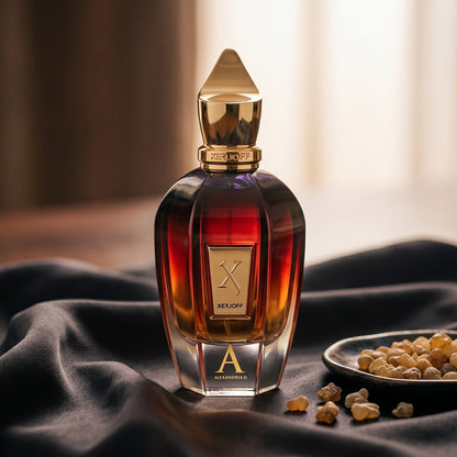 Xerjoff Oud Stars Alexandria II EDP on charcoal raw silk with amber resin pieces near the bottle base