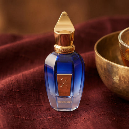Xerjoff Torino 21 on raw silk of oxblood color with a brass bowl of ambergris tincture