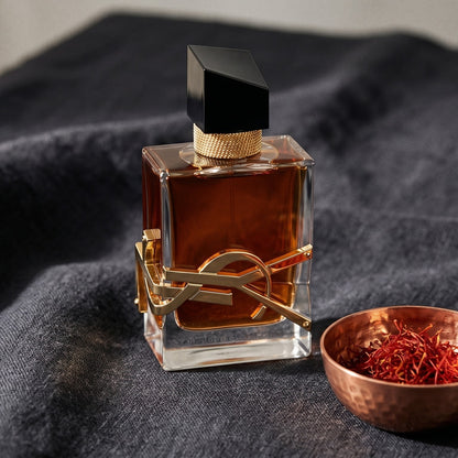 Yves Saint Laurent Libre Le Parfum on charcoal linen with a small copper bowl of saffron threads
